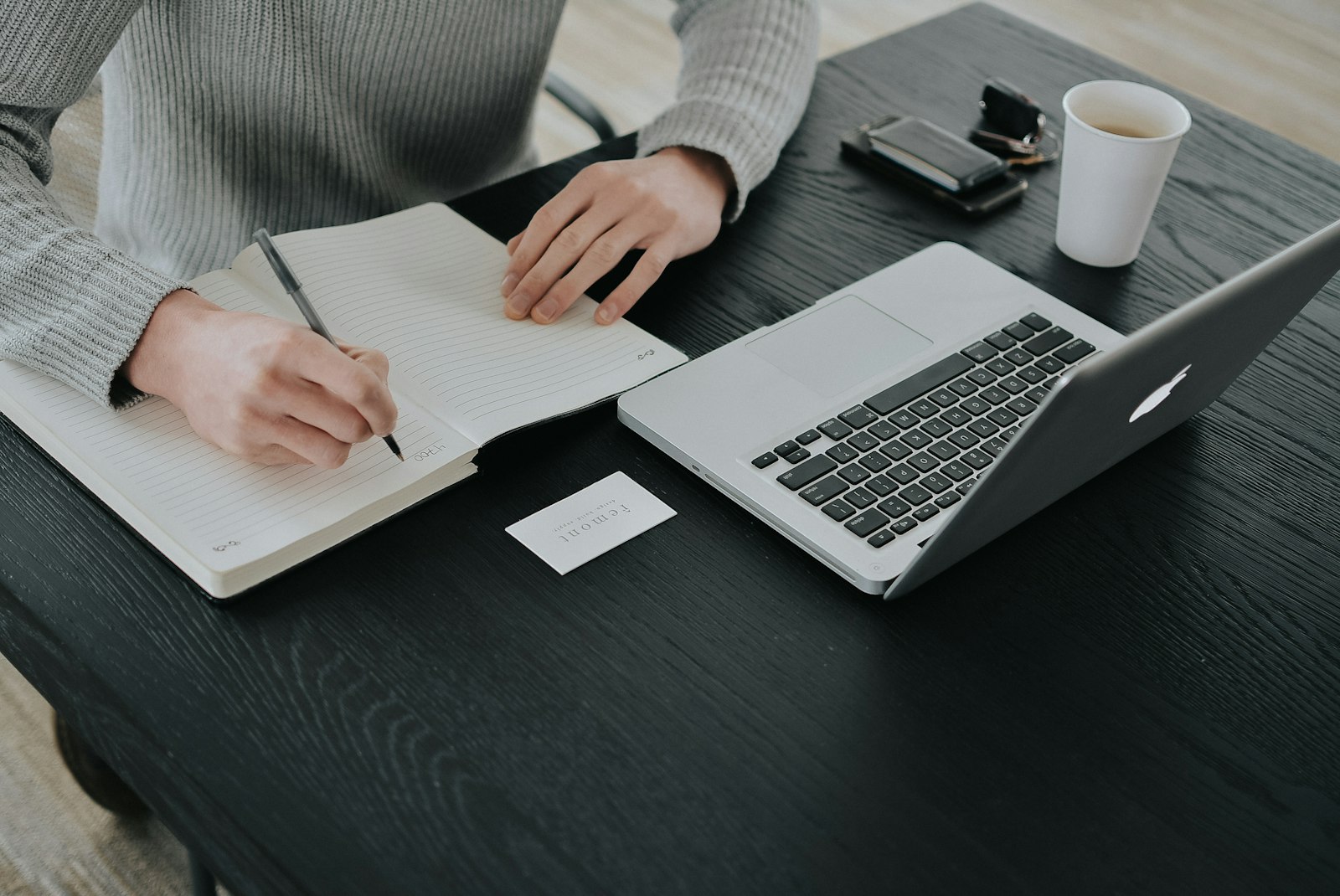 Remodeling company owner working out an SEO budget in a notebook before hiring a home remodeling SEO company