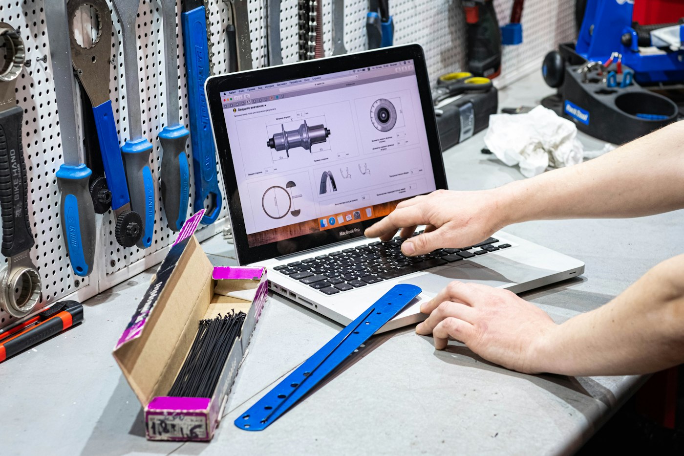 Contractor working on a laptop surrounded by tools