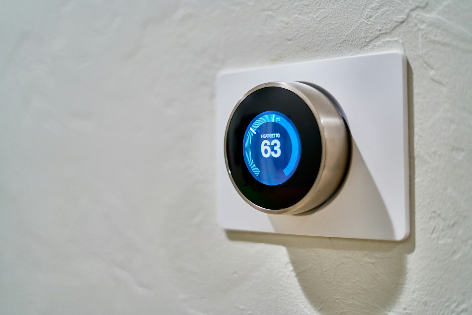 Wall thermostat showing the indoor temperature setting in a home