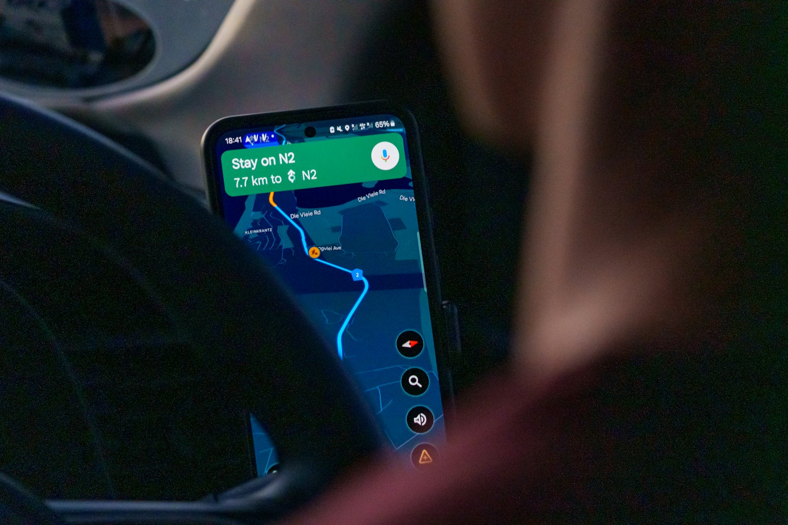 Phone navigation in a car, like a homeowner checking directions to a remodeling showroom found online
