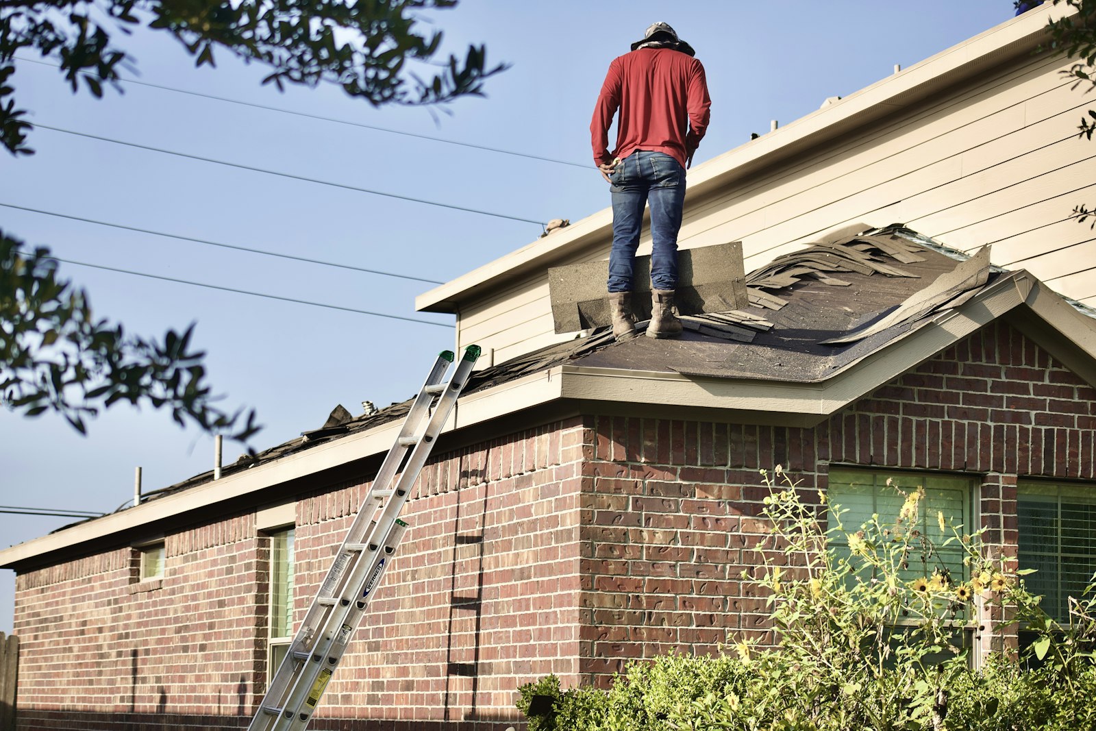Roofer standing on a residential roof, the kind of local expert answer engine optimization helps homeowners find