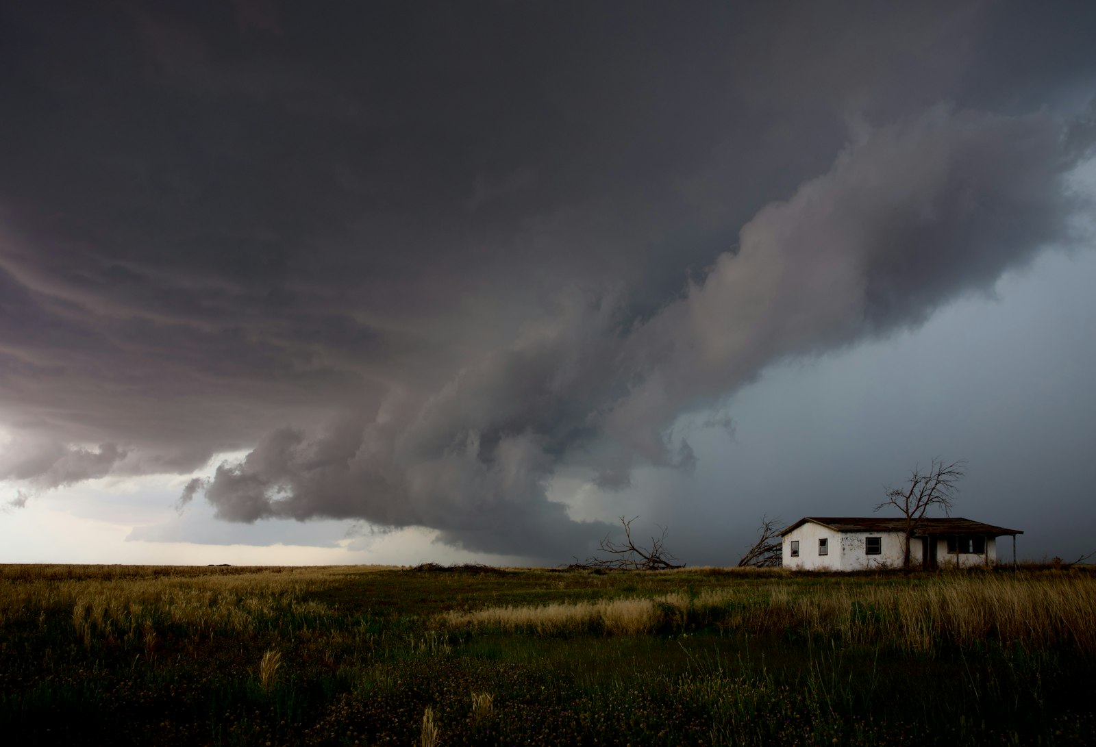 Storm clouds gathering over a house, the moment roofing contractors see local search demand jump