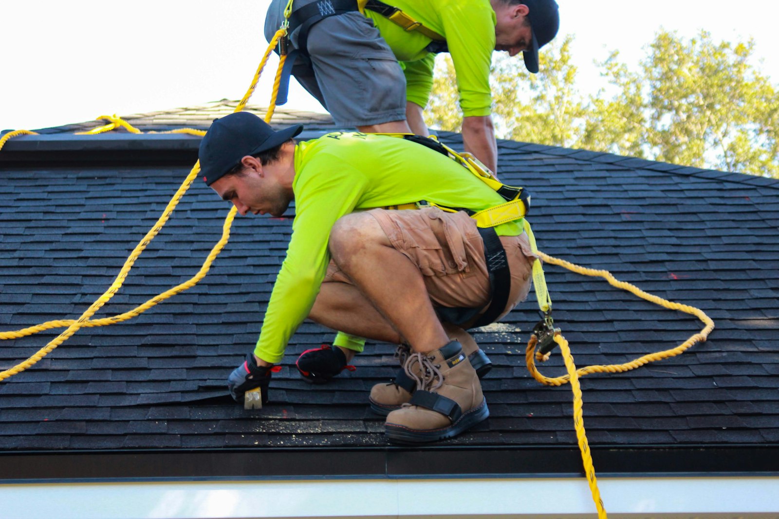 Two roofers working on a house, the kind of contractors who ask practical questions about SEO for roofing contractors